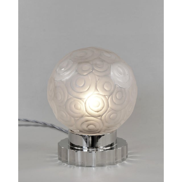 SABINO A gorgeous French 1925-1930 art deco table lamp in nickel plated solid brass or bronze holding a small sphere in...