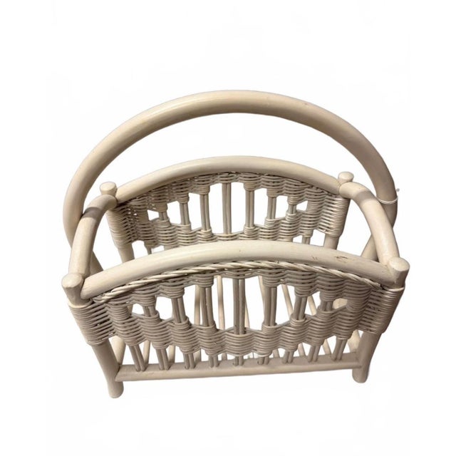 Add a touch of airy, coastal charm to your space with this vintage whitewashed rattan magazine rack. Perfectly balancing...