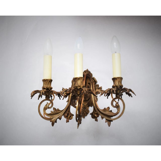 2 large three-light wall lamps in the style of the Rococo. Central medallion (one lamp a nobleman and the other a courtly...