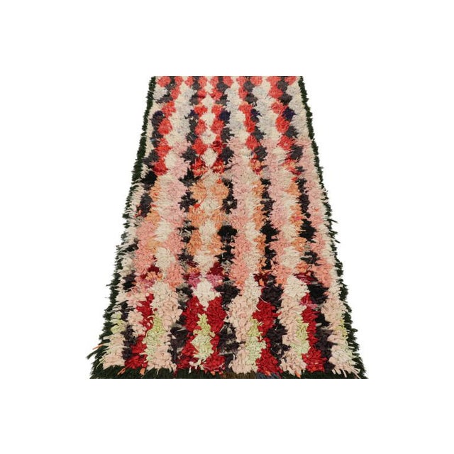 Hand-knotted in wool and originating from Morocco circa 1950-1960, this 3x6 vintage Moroccan rug is an extremely rare...