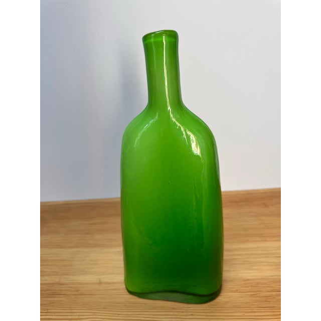 Vivid green hand-blown glass vase with a sculptural, bottle-like form. The bold color and clean silhouette make it a...