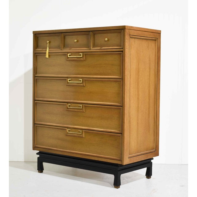 This mid century highboy dresser by American of Martinsville has seven drawers and Chinoiserie-inspired detailing. Three...