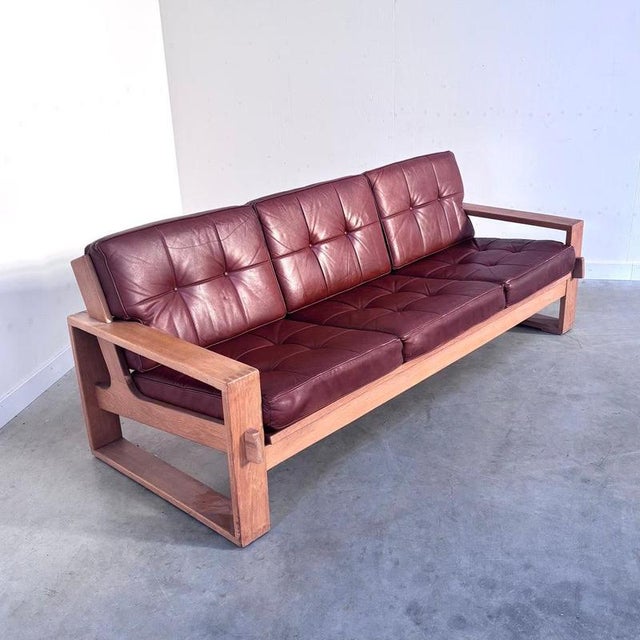 Remarks: Lounge sofa in Asko Bonanza style, 1970s. Oak wood frame with brown leather upholstery. Sofa is in very good...