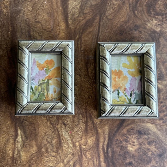 This delightful pair of mini floral watercolors brings a burst of gentle color to any space. Loose, impressionistic...