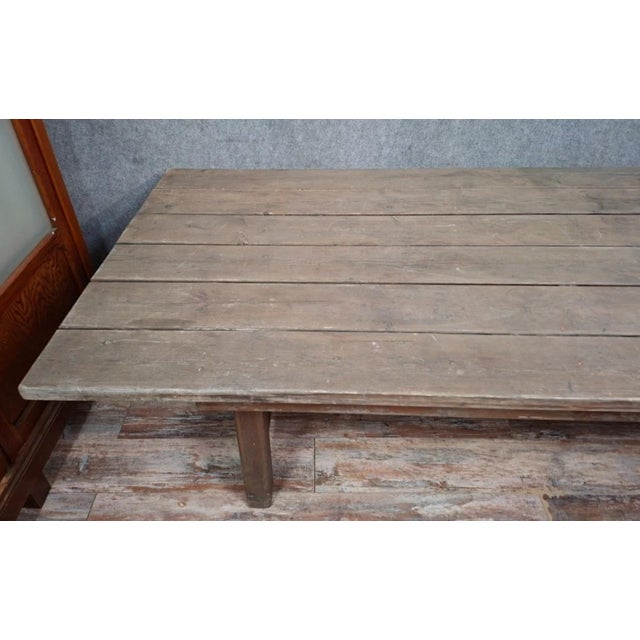 Large 19th-century solid wood farmhouse table with authentic, rustic charm. this table features a wide, antique plank top,...