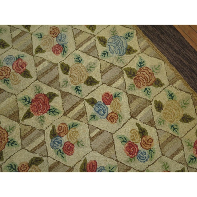 A room size mid-20th century American Hooked rug with a floral all-over design on gray khaki striped field and oatmeal...