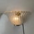 Set of two sconces in clear murano glass, made with the graniglia technique, which produces a granular, textured effect...
