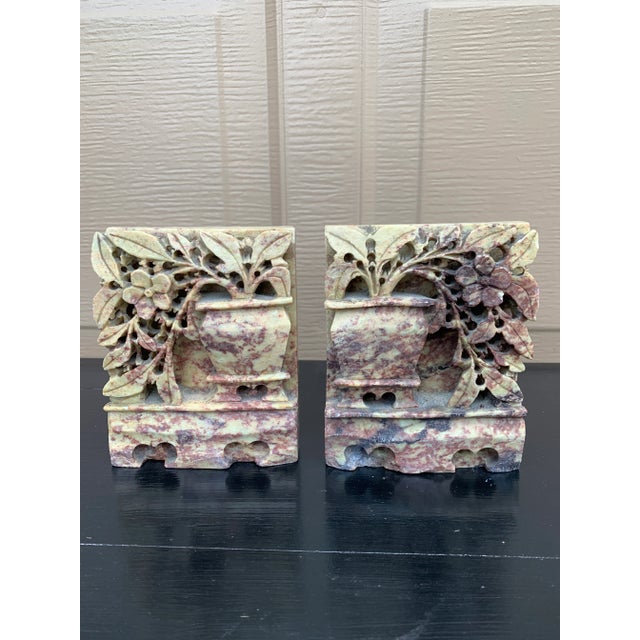 A beautiful pair of Chinoiserie Art Deco period hand carved solid soapstone bookends in the form of flowering plants...