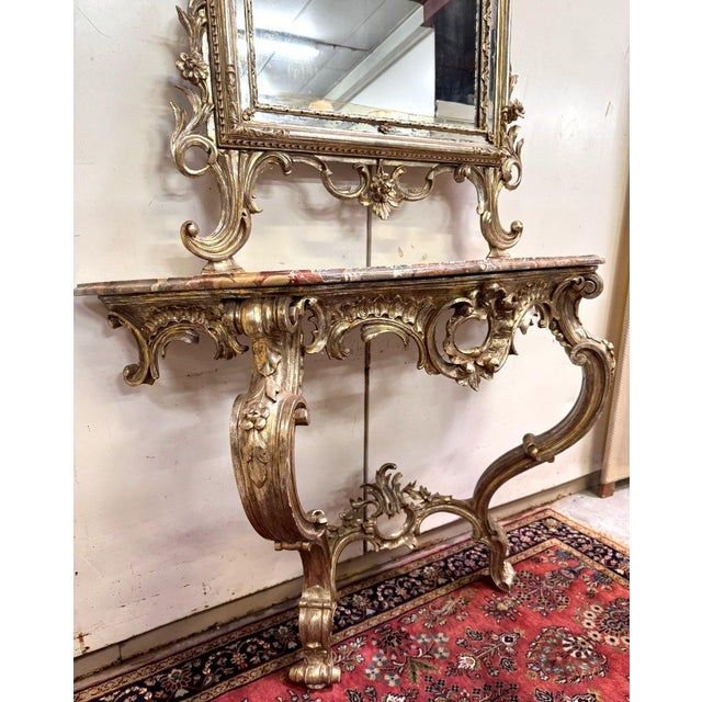 Important curved château console + Louis XV style mirror in gilt and silvered wood with a highly ornate shape and abundant...