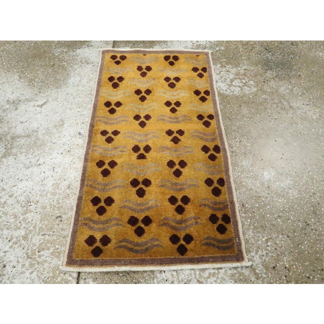 This Mid-20th century Turkish Art Deco throw rug, measuring 1' 8" x 3' 0", is a striking example of modernist influence...