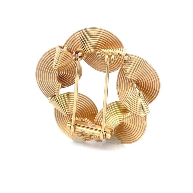 This is a lovely vintage designer signed brooch; it is 14k pink gold with chasing grooved design twist floral style...