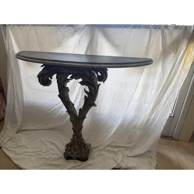Hollywood Regency Palm Console Table with a Silvered Base with a Painted Faux Marble top in the style of Serge Roche....