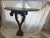 Hollywood Regency Palm Console Table with a Silvered Base with a Painted Faux Marble top in the style of Serge Roche....