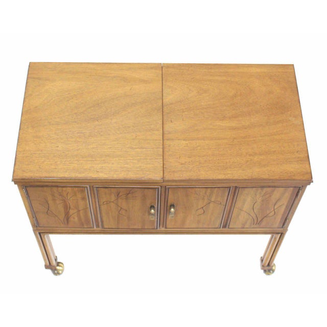 Miid-century modern flip top bar cart server on wheels. Faux bamboo legs.