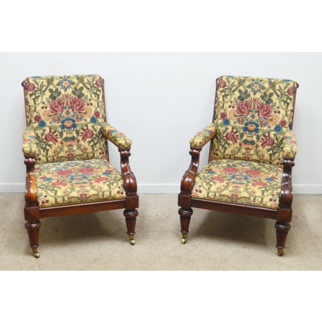 Pair of Ralph Lauren Arm Chairs. Store item #548. They feature brass castors and wood frame.