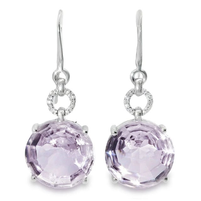 18K white gold hanging earrings featuring 2 cabochon amethysts accented by 20 single-cut diamonds totaling 0.1 ct....