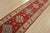A tribal Caucasian Kazak runner hand-knotted with fine wool on a cotton foundation. This rug features a row of geometric...