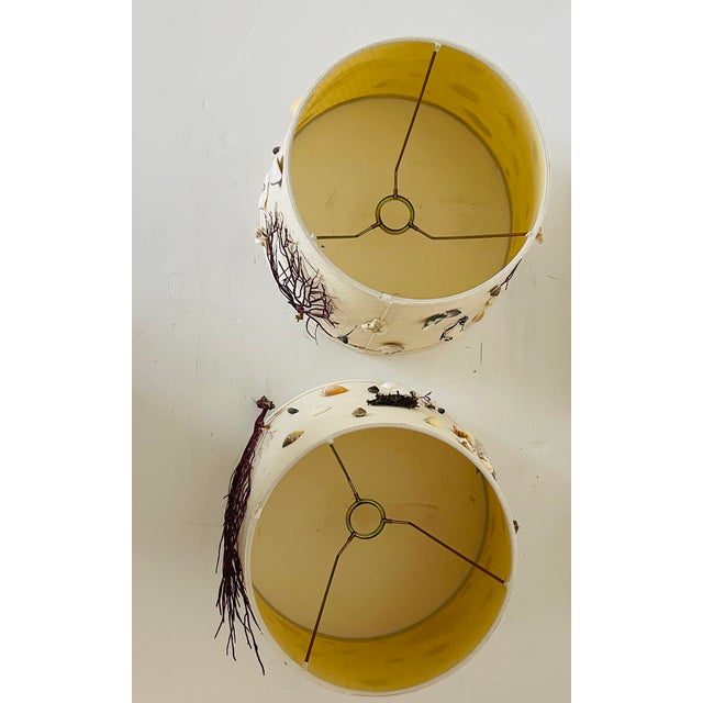 Custom pair of lamp shades decorated with sea shells, sea whip branches, oyster shells, coral fragments.