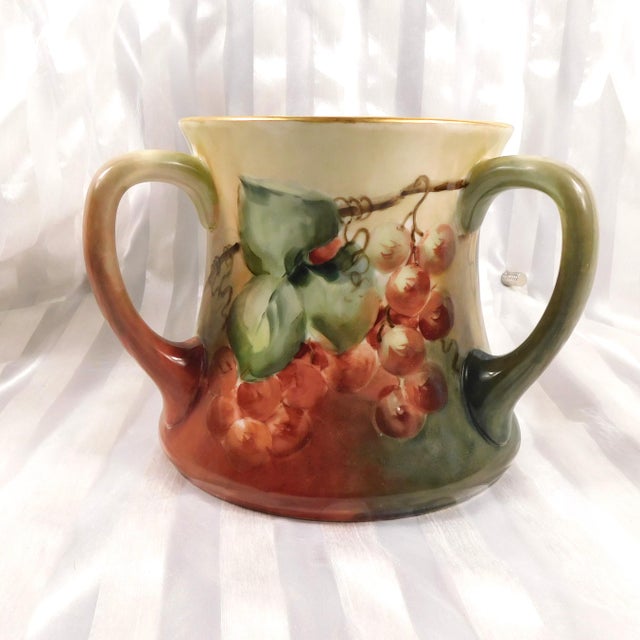 This is a large three handled pot by William Guein Limoges. Each side is different. One side is dark green with purple...