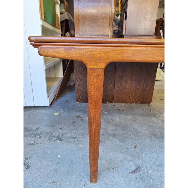 Beautiful "Made in Denmark" Teak Dining table in good vintage condition with a portion of the end being somewhat weathered.