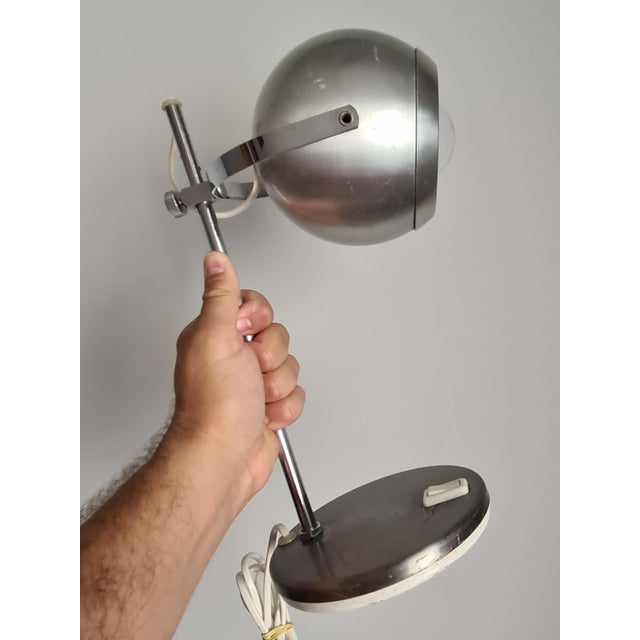 Elegant adjustable desk lamp in the Space Age style, emblematic of 1970s design. This piece is distinguished by its...