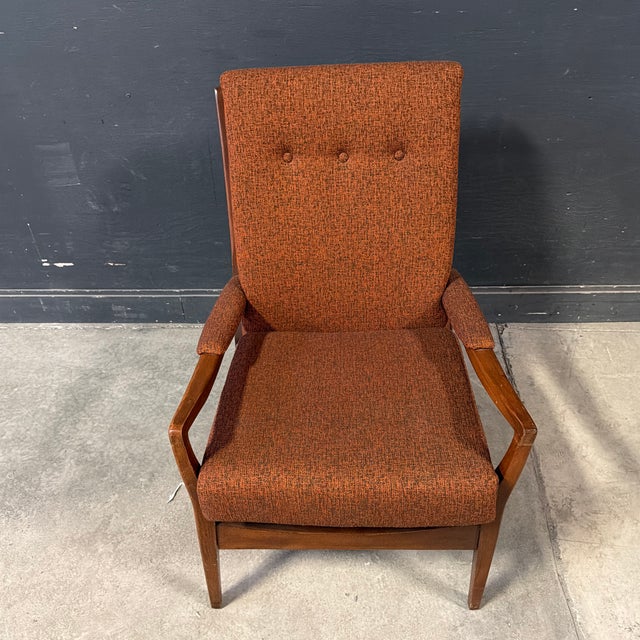 Handsome physique, classic mcm style. Fantastic vintage British-made Danish-style lounge chair in a rust-colored vintage...