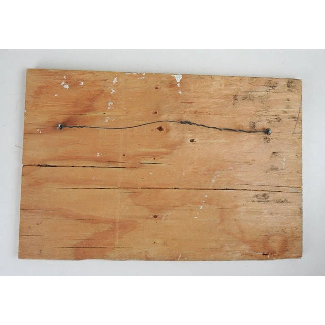 Abstract folk art painting on wood. Signed illegibly in pencil along upper edge. Unframed, hanging hardware attached to...