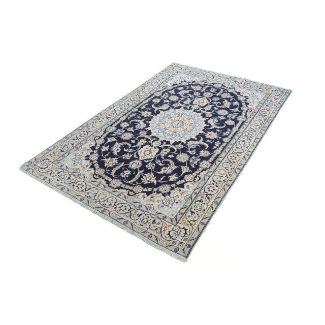 This elegant Nain 9La rug was knotted using the finest traditional handwork and impresses with its artistic design and...