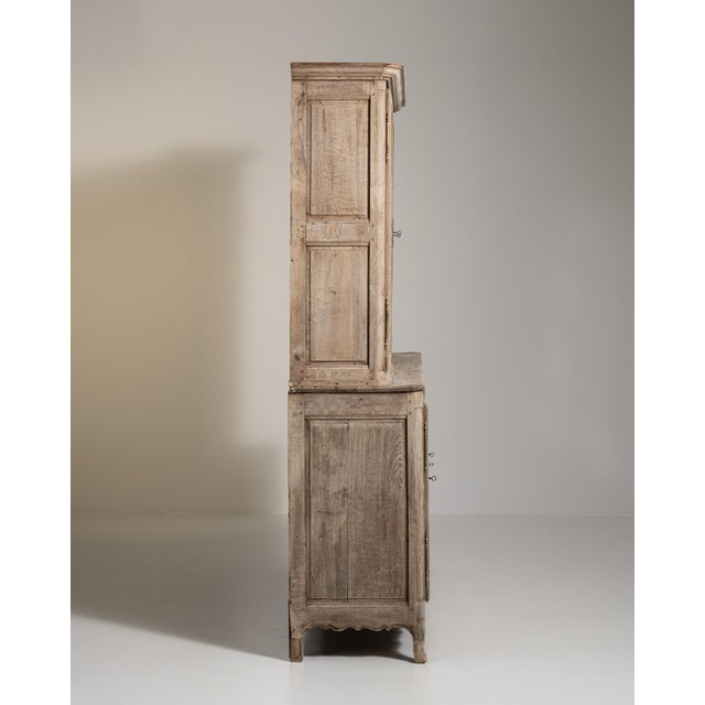 A brown wood, French Provincial-style vitrine from the 19th century, made in France. Crafted in wood with glass detailing,...