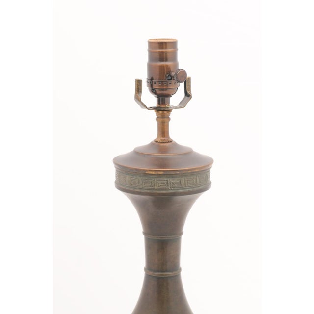 Produced by the Marbro Lamp Company in the 1950s, these towering bronze lamps are striking interpretations of an ancient...