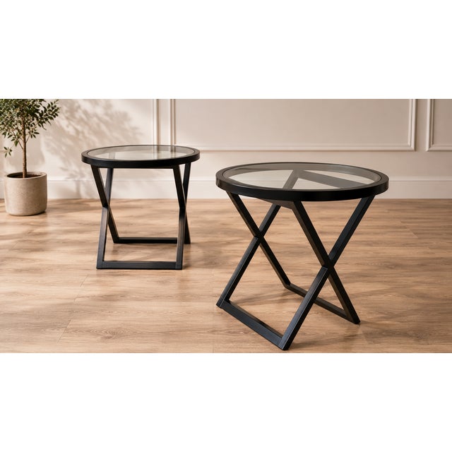 Elegant pair of Ralph Lauren Mercer Street occasional tables, featuring substantial black-finished mahogany X-frame bases...