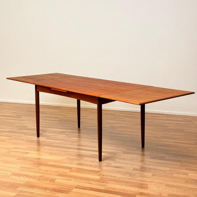 Dining table was manufactured in Denmark in the 1950s-60s . It is made of teak veneer on top surface and in teak wood on...