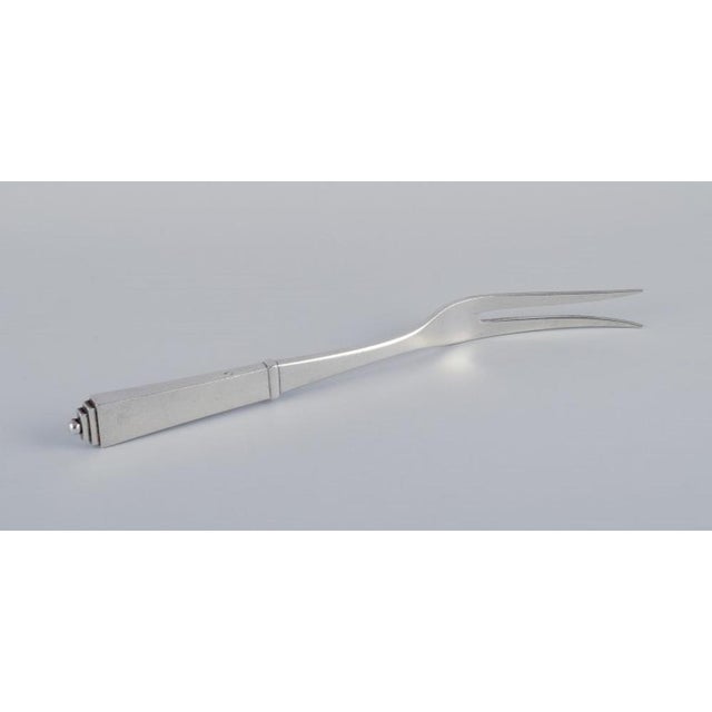 Georg Jensen Pyramid. Carving fork in sterling silver. Hallmark: After 1944. In excellent condition with a minor...