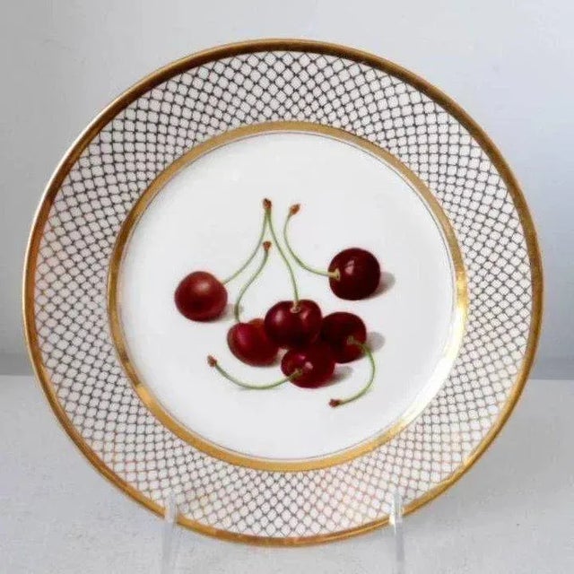 An exceptional Paris porcelain cabinet plate by Edouard Honore. Decorated with a central reserve of hand painted cherries...