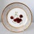An exceptional Paris porcelain cabinet plate by Edouard Honore. Decorated with a central reserve of hand painted cherries...