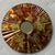 Excellent Pre-Owned Condition. Colorfully dramatic verre eglomisé-style reverse painted “sunburst”-shape wall mirror...