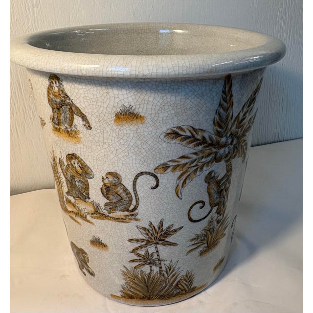 Beautiful porcelain cachepot jardiniere in a whimsical chinoiserie design with a vibrant, multi-tonal wrap-around scene of...
