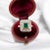 18 carat gold ring (750 thousandths) centered on an emerald of approximately 0.70 carat in a setting of 16 brilliant-cut...