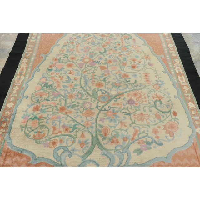Originating from China circa 1920, this 6x9 antique rug is a profound exploration of spiritual symbolism and luxury...