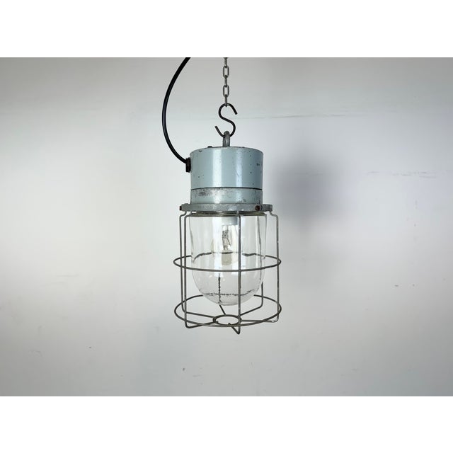 This Industrial hanging light was made by Elektrosvit in former Czechoslovakia during the 1970s. It features a cast...