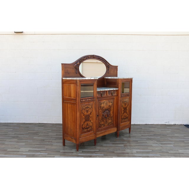 An elegant Early 20th Century French Art Deco buffet sideboard showcasing exceptional craftsmanship and timeless design....