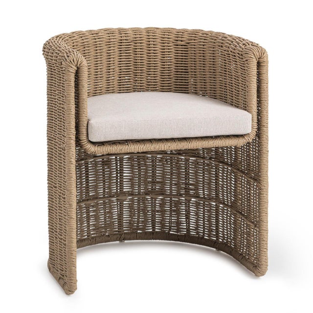 Hand-woven faux wicker outdoor chair featuring a softly rounded, sculptural silhouette and a tightly wrapped, durable...