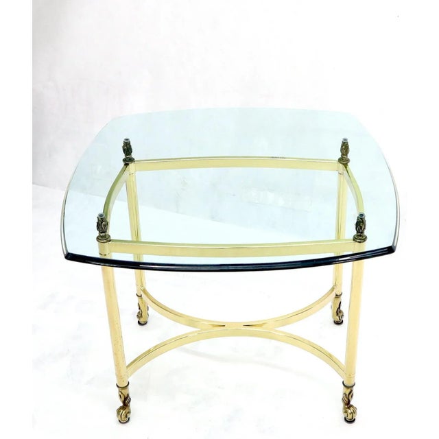 Vintage Italian polished brass bass cast brass finials glass top coffee table.