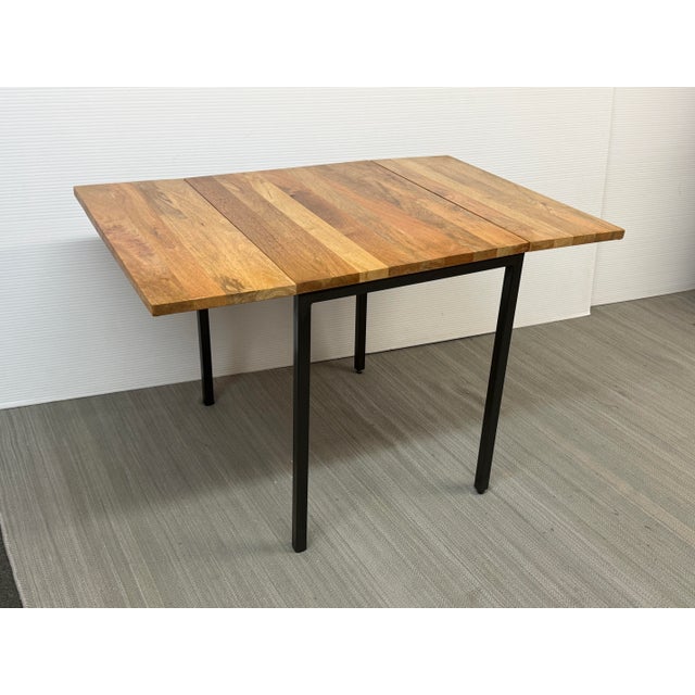 Design Plus Gallery presents the Box Frame Drop Leaf Table from West Elm. This s a space-saving dining table that can...