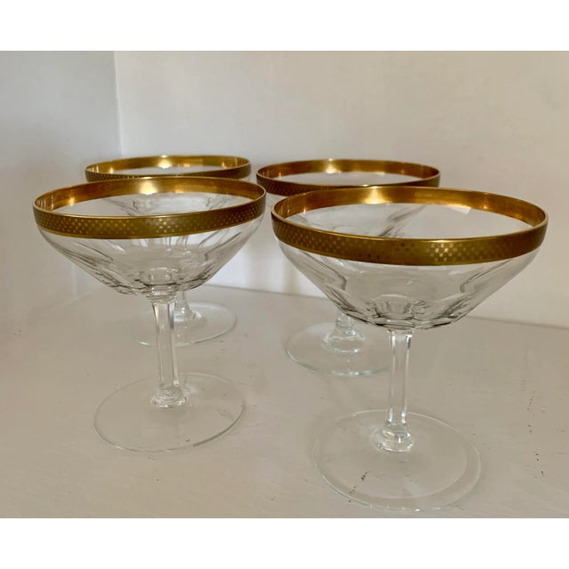 Art deco set of 4 champagne coupes with faceted glass and cut stems. These coupes are adorned with a 24K checkered gold...