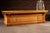 Substantial antique general store counter constructed in solid oak with a paneled facade, projecting work surface, and...