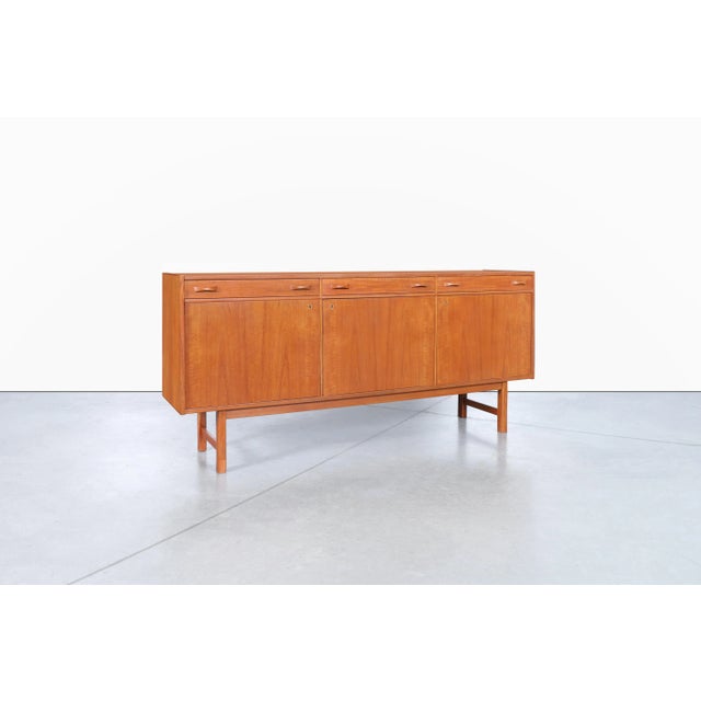 Designed by Tage Olofsson for Ulferts Mobler in Sweden during the 1960s, this mid-century Swedish teak credenza is a...