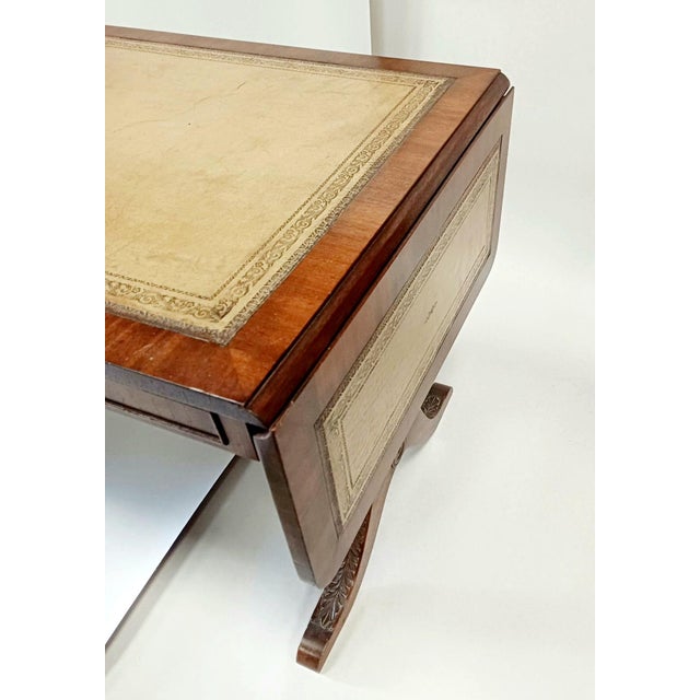 Elegant extendable Mahogany coffee table from Bevan Funnell Ltd. Beautiful gold-tooled leather top and acanthus carvings...