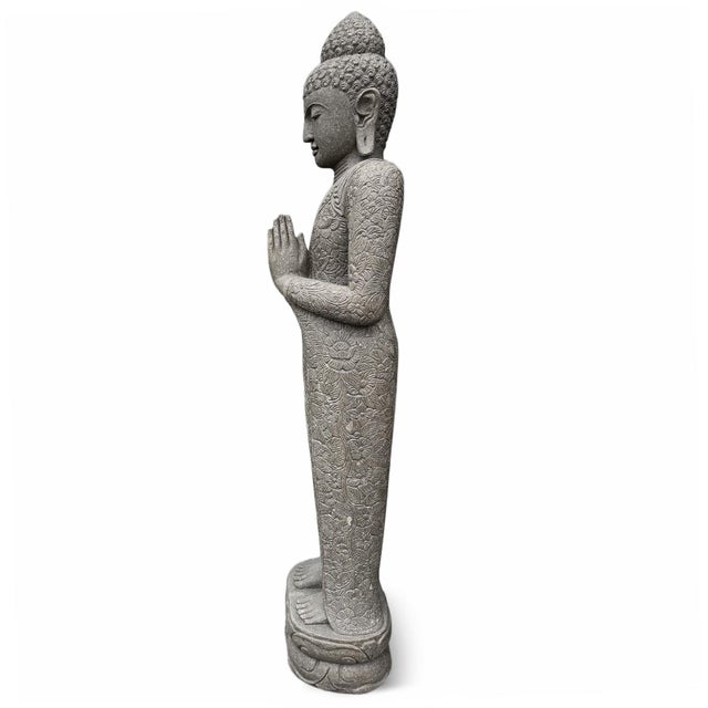 Monumental stone vintage Buddha statue hand-carved in Indonesia. This serene figure is rendered in a traditional prayerful...