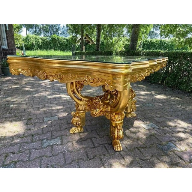 A striking 1980 Italian Baroque-style dining set, consisting of one dining table and six matching chairs. This elegant...